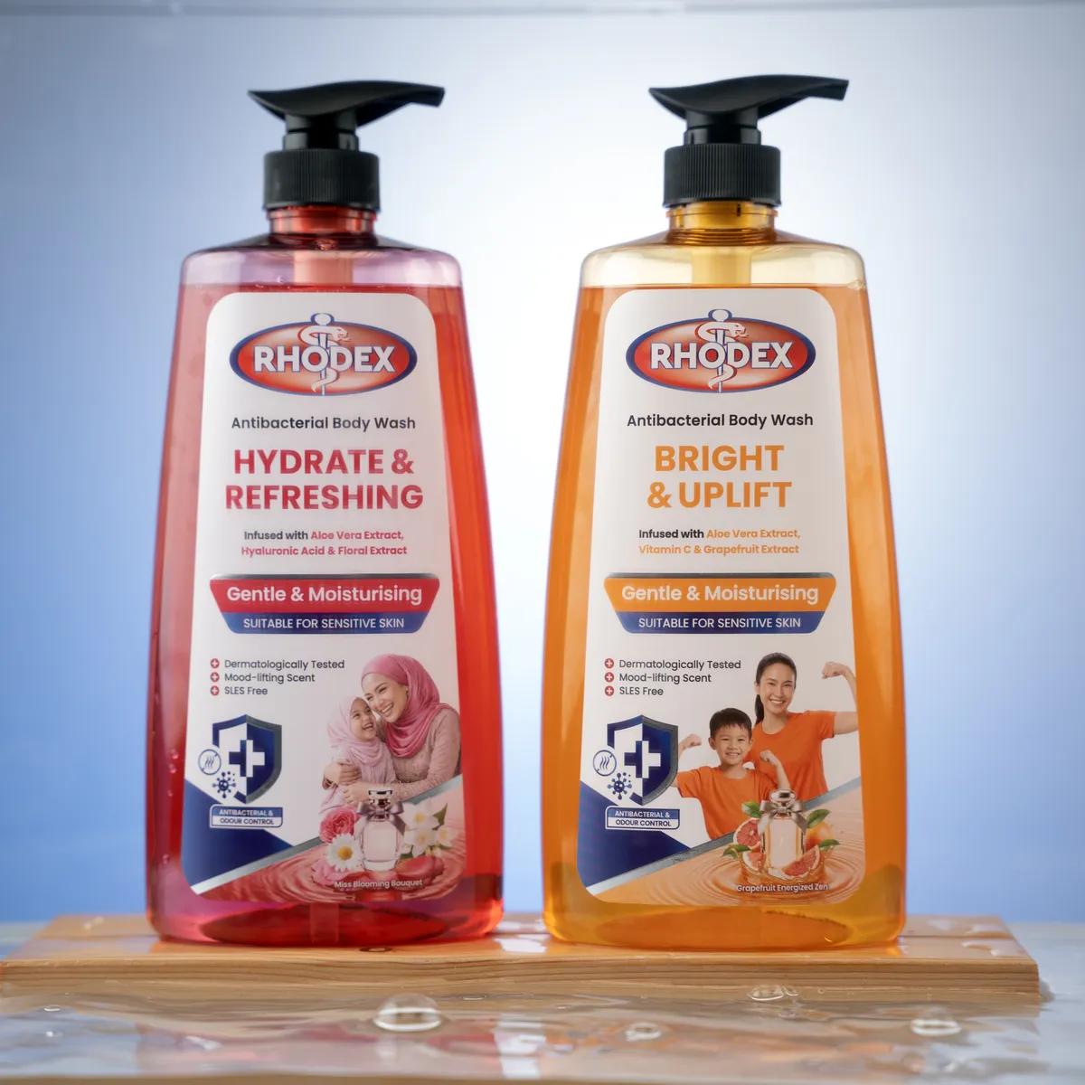 RHODEX Hydrate & Refreshing and Bright & Uplift standing side by side on a wet wooden tray
